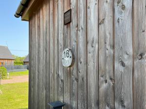 a wooden building with a clock on the side of it at Ivy - Uk50105 in Brigg