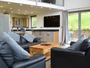 ein Wohnzimmer mit zwei Sofas und einem Tisch in der Unterkunft Heartwell Cottage in Wolsingham