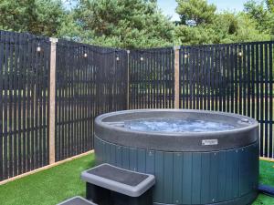 a hot tub in a yard next to a fence at Fairways Retreat 2 - Uk50247 in Cottingham