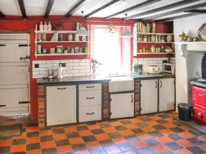 a kitchen with white cabinets and a counter top at Farm House - Uk50262 in Llandeilo