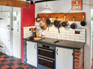 a kitchen with a stove and some pots and pans at Farm House - Uk50262 in Llandeilo