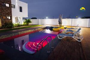 a swimming pool with a table and chairs in it at Asa Beach Villa in Trofwi