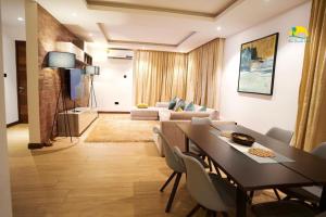 a living room with a dining table and a couch at Asa Beach Villa in Trofwi