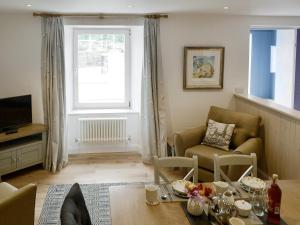 a living room with a couch and a table at Blue Beach House in Ilfracombe