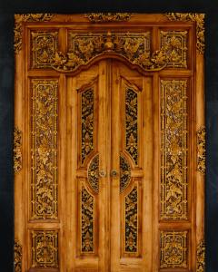 a wooden door with intricate designs on it at NEW Cozy, Smart, Renovated Flat Western Standard in Ubud