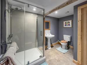 a bathroom with a shower and a toilet and a sink at Townhead Mill in Carronbridge +14 photos