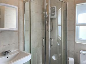 a bathroom with a shower and a sink at Rosie's Cottage in Bridlington +4 photos