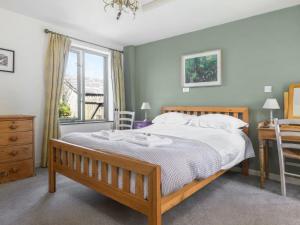 a bedroom with a bed and a desk and a window at The Roost in Saint Breward