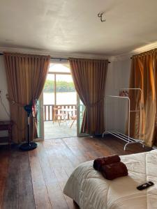 a bedroom with a bed and a view of a patio at Rumah Sungai Impiana PCB Room 7 in Gua Sai
