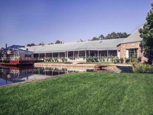 バララットにあるMercure Ballarat Hotel & Convention Centreの川が目の前に広がる大きな建物