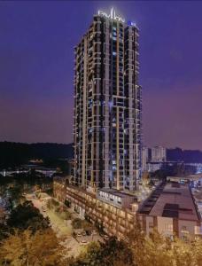 a tall building with a sign on the top of it at Cozy Mayfair Homestay in Puchong