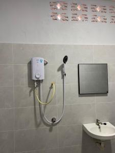 a shower in a bathroom with a sink at Rumah Sungai Impiana PCB room 2 in Gua Sai