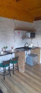 a kitchen with a table and chairs in a room at Chalé Sonho Diniz 3 in Monte Verde