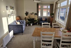 a living room with a blue couch and a table at Best room near the stadium, train station, & parliament precinct in Wellington