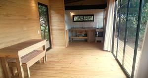 a porch of a wooden cabin with a sink and a counter at Mapuche de Puntanegra in Punta Colorada
