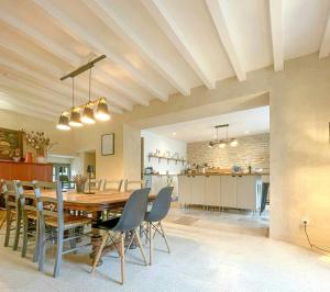 a dining room and kitchen with a table and chairs at Family House In The Heart Of Burgundy in Gigny