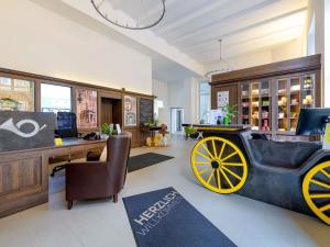 a store with a carriage in the middle of a room at Ibis Styles Trier in Trier