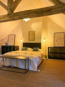 a bedroom with a large bed in a room at Family House In The Heart Of Burgundy in Gigny