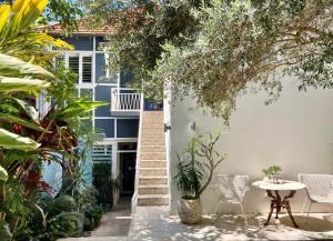 a patio with a table and chairs in front of a building at kookaburra beach house coogee in Sydney