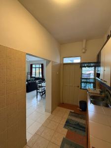a kitchen with a sink and a dining room at Cameron Prima Villa Homestay in Tanah Rata +4 photos