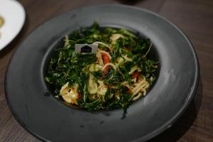 a bowl of food on a plate on a table at Sek Sky Villa&Cafe in Ban Kham Kom