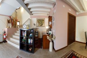 a hallway with stairs and a book shelf with books at Sweet Home in Treviso