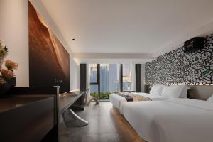 a hotel room with two beds and a large window at 重庆MAX范思酒店解放碑来福士店Chongqing MAX Van Hotel Jiefangbei Raffles in Chongqing