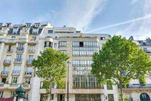 a large white building with trees in front of it at Villa Luxembourg in Paris