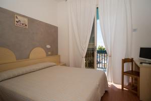 Postel nebo postele na pokoji v ubytování Hotel Conchiglia + 37 fotografií