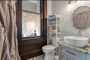 a bathroom with a sink and a toilet and a mirror at MI CASA in Frankfort +52 photos