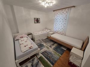 a small room with two beds and a window at Way Unterkunft in Sankt Peter-Freienstein