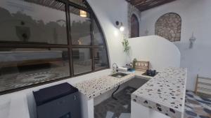 a kitchen with a sink in a room with a window at Hanara Bohemian Villa in Bandung
