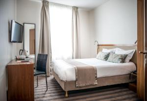 a hotel room with a bed and a window at Art Hotel Eiffel in Paris