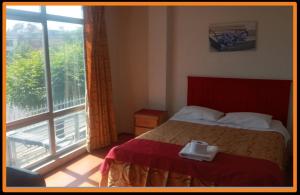a bedroom with a bed and a large window at HOTEL AREQUIPA ANDINOS in Arequipa +12 photos