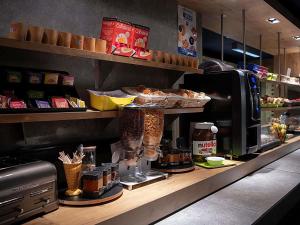 a kitchen with a counter with bread and a coffee maker at Ibis Budget Le Havre Les Docks in Le Havre