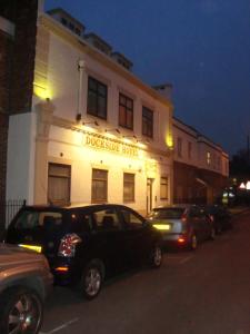 a black truck parked in front of a doheny hotel at Dockside Hotel in London