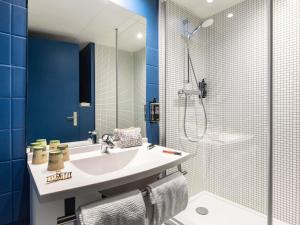 a bathroom with a sink and a shower at ibis budget Saint Dié des Vosges in Saint Die