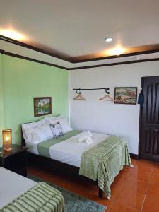 a bedroom with two beds and a table with a lamp at DaRosa Del Mar in Santa Monica