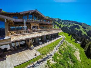 a chalet with a balcony in the mountains at BichlAlm Berggasthof in Kitzbühel