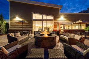 a patio with chairs and a fire pit in front of a house at Residence Inn Rochester Henrietta in Rochester