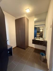 a bathroom with a sink and a cabinet in it at Ayer Keroh Gateway in Ayer Keroh