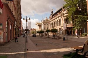 a city street with buildings and people walking on the sidewalk at hostelswidnicka24 in Wrocław