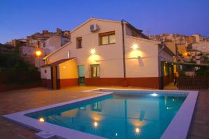 a swimming pool in front of a house at CASA LA FÀBRICA in Horta de San Joan