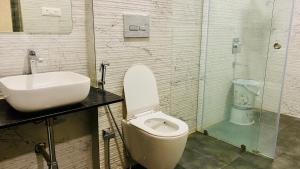a bathroom with a toilet and a sink at Hotel RS Inn in Indore