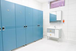 a bathroom with blue cabinets and a sink at Karvon Plaza Hotel in Samarkand