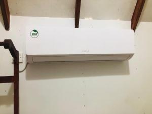 a white printer sitting on top of a wall at Kurulu Kele Family Tree House in Sigiriya