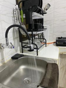 a kitchen sink with water coming out of a faucet at Casa Bellah Sunset in Watamu