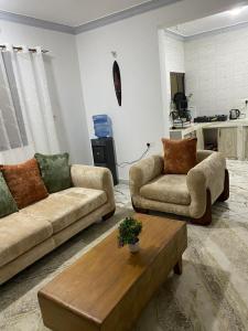 a living room with two couches and a coffee table at Casa Bellah Sunset in Watamu