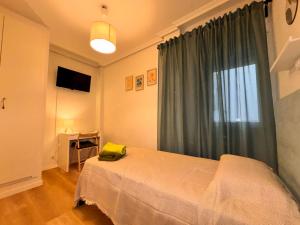 Ένα ή περισσότερα κρεβάτια σε δωμάτιο στο Rooms Carlos - junto a Plaza Mayor