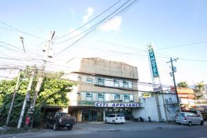 ein Gebäude mit davor geparkt in der Unterkunft GV Hotel - Dipolog in Dipolog City